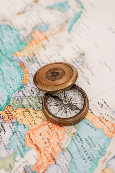 Compass on a map, symbolizing guidance and direction in book coaching services.