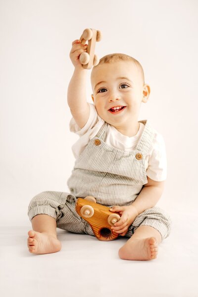 studio portrait of toddler on white backdrop