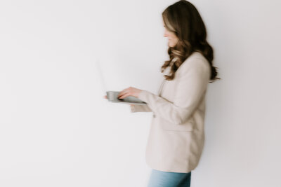 Website copywriter holding a laptop
