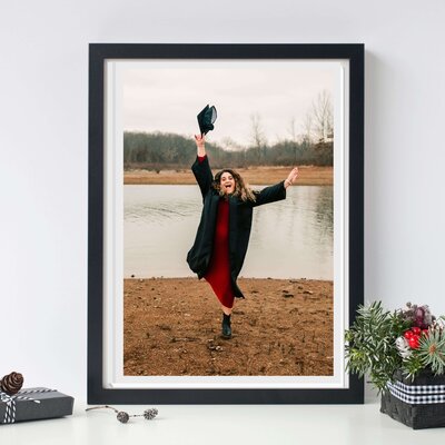 Framed photo of senior grad throwing cap during Branson senior photographer session