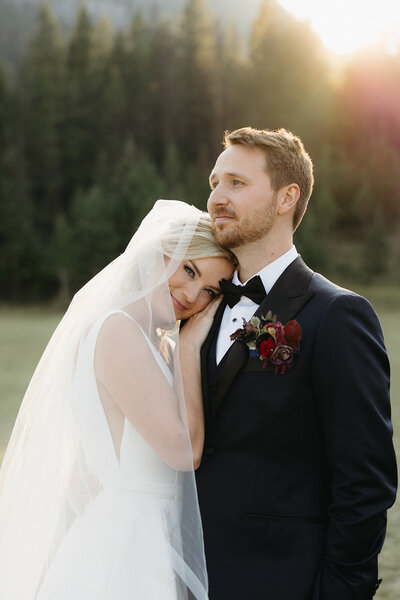 Bride and groom wedding photo in outdoor mountain scene.