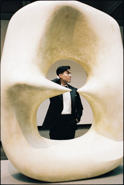 35mm film editorial style photo of groom inside an art gallery in AGO Toronto