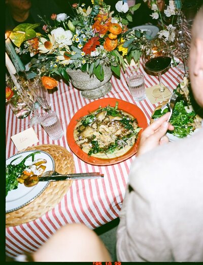 Rustic farm-to-table table arrangement with candles, fresh flowers, and seasonal dishes at a Los Angeles farm dinner.