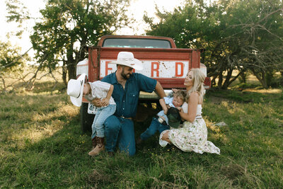 western family photos in front of a vintage ford truck