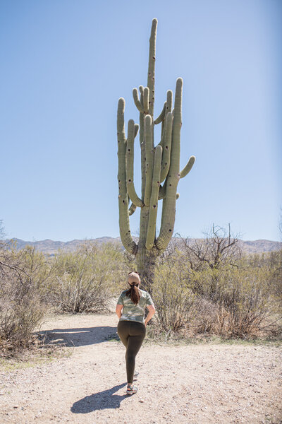 woman standing in front of cactus