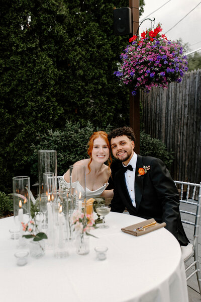 a bride and groom smiling at their reception