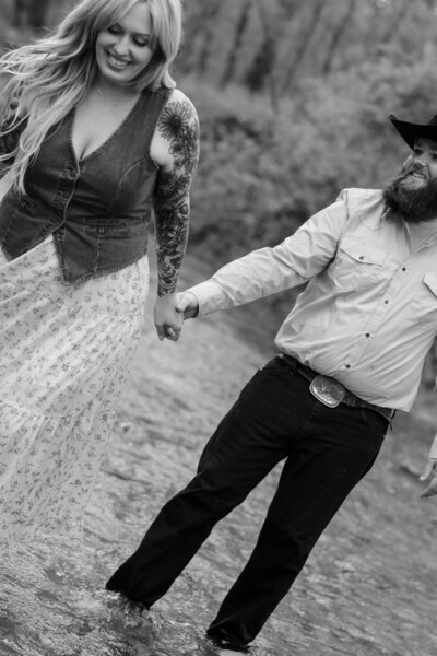 Couple captured in a romantic moment outdoors, surrounded by nature’s beauty, showcasing their love against a serene landscape.