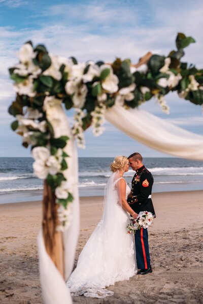 bride and groom embracing on beach