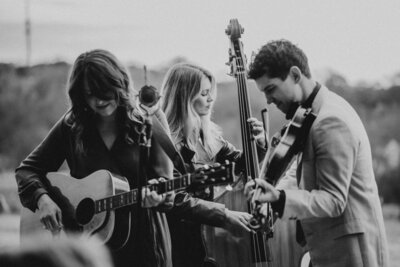 Bride in Rivini gown with statement bow & groom in black tuxedo having first wedding dance at Kalamazoo Country Club in Michigan