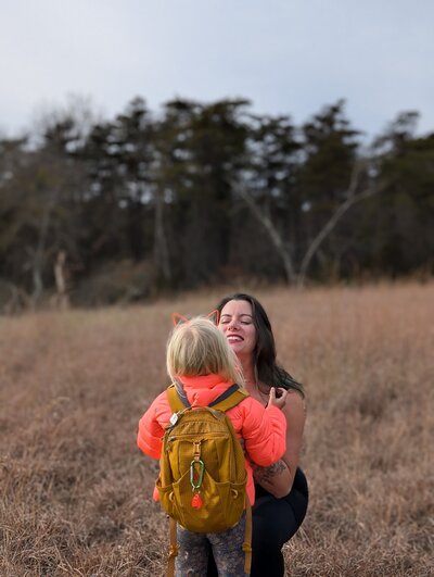 Julie Pokorny, craniosacral therapist in Baltimore Maryland playing outside with her 6 year old daughter. 