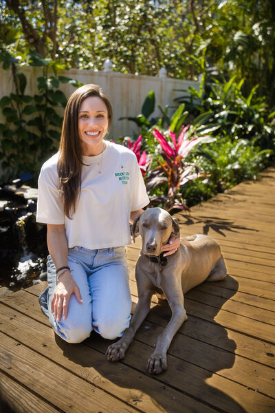 Brooke sitting in the garden with her dog