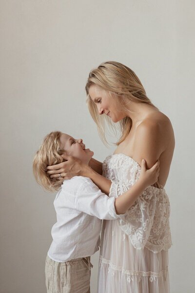 Mother and child embracing in soft studio light through Michigan photography