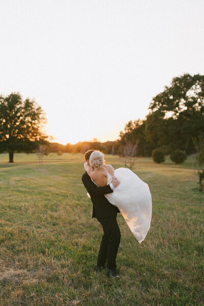 Groom carrying bride