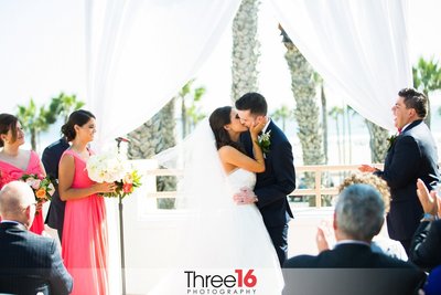 Bride and Groom share their first romantic kiss at the altar