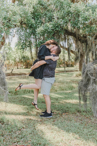 engaged couple kissing under tree at Georgia engagement session
