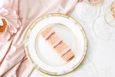 Strawberry and pink champagne wedding cake portion on vintage plate