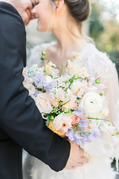 bride and groom leaning in to kiss each other