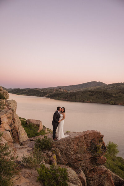 Couple embraces on a cliff edge at Horsetooth Reservoir in Fort Collins, Colorado