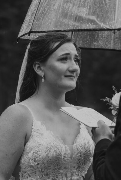 A black and white photo of a couple kissing during their elopement in Glacier National Park.