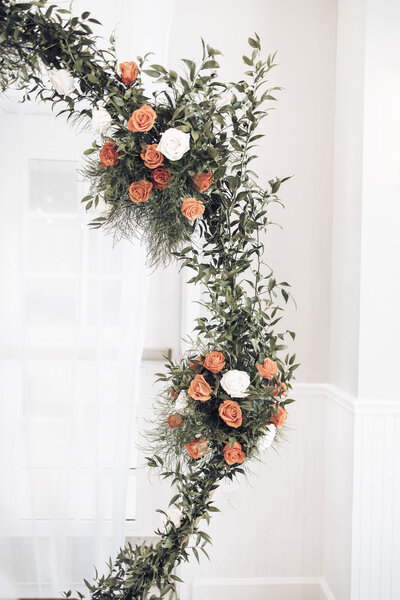flower arch with peach and white roses