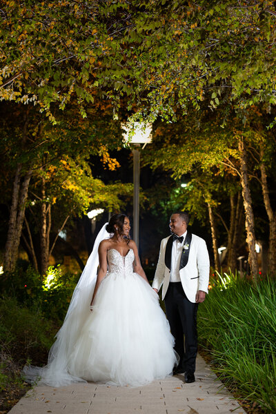 Bride and groom walking outside of Hotel Crescent Court in Downtown Dallas