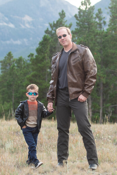 Janeil Anderson’s husband and son outdoors in Montana, reflecting the family-first values behind Seventh and Anderson, a wedding stationery studio.