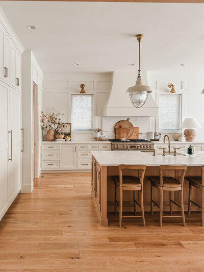 The kitchen at Woodlawn House is a chef's dream with a mix of painted and natural cabinetry and marble countertops