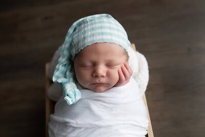 newborn-baby-boy-in-blue-striped-sleepy-cap