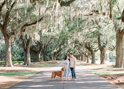 couple standing wiht their dog at caledonia golf course