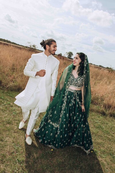 Vegan asian couple walking through a field photographed with direct flash