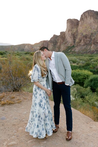 Man sweetly kisses woman on cheek at a canyon overlook