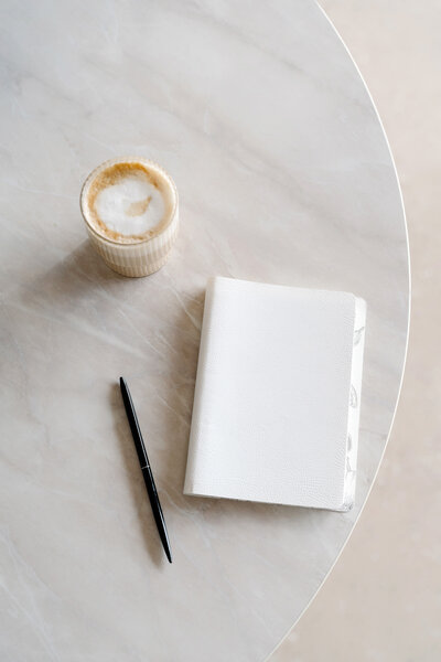 flatlay of candle and notebook