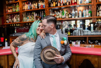 groom glances back at bride in a bar
