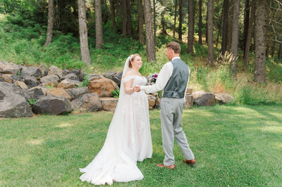 Wedding potrait at twin creeks farm summer wedding in idaho wedding venue with bride and groom sharing a moment during their first look