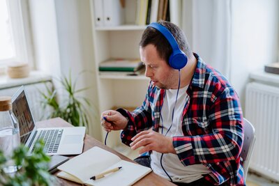 young man with disability wearing headphones