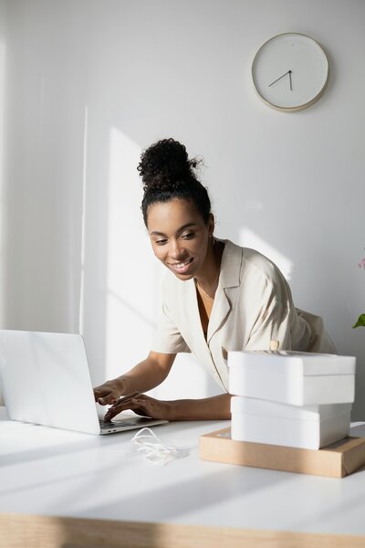 Woman working on her Macbook on a desk