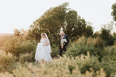 Bride and Groom walking through the mountains