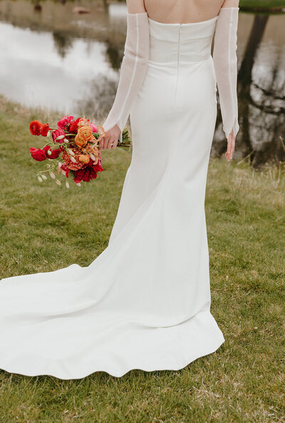 Spring wedding bouquet with protea, lilies, and garden roses