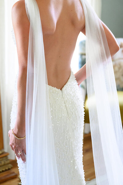 Elegant backless wedding dress with sheer veil details, styled for a romantic Austin wedding planned with care and confidence.