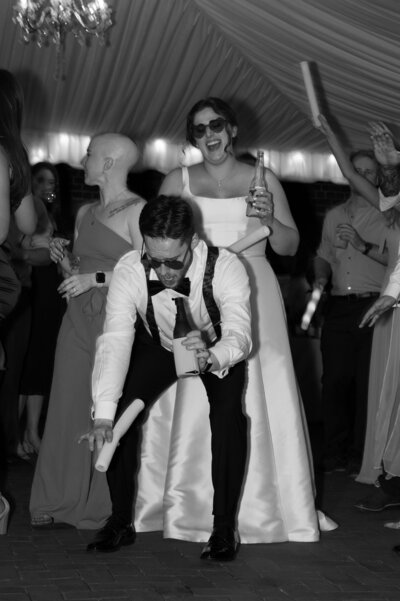 A newlywed couple dancing together at their wedding reception