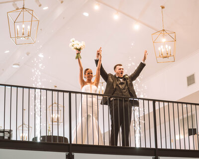Married couple in loft with cold sparklers going off in the background
