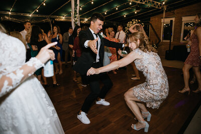 Groom dancing at reception