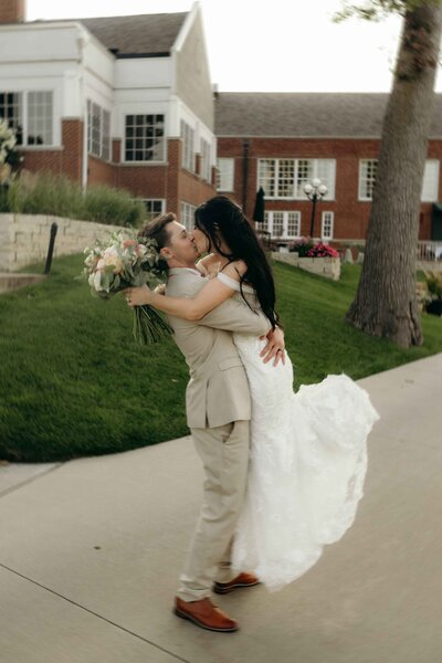 Newlyweds spin and kiss outside the Cedar Rapids Country Club in Iowa.