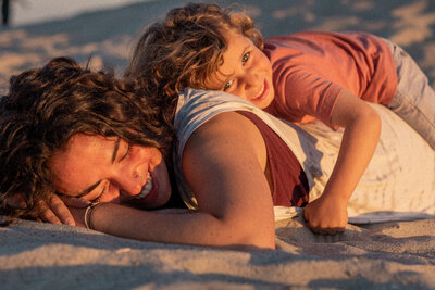 mother and son playing on the beach