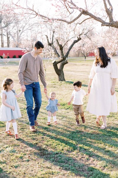 family outside in peach orchard for peoria illinois family photos 