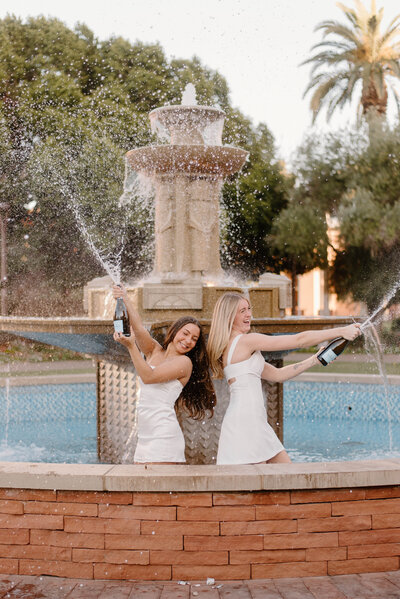 ASU grads pop champagne in the fountain at Old Main