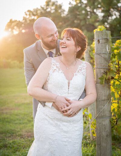 grooms holds brides face amongst flowers