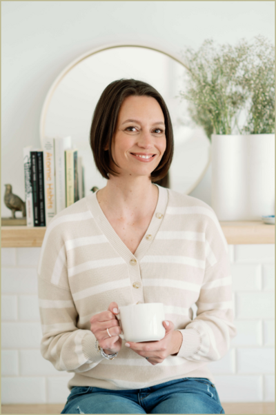 Kelly Fiorini holding a cup of tea smiling