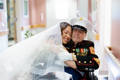 A newlywed leaning down and hugging their grandparent 