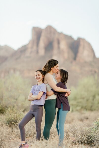 mother posing with two daughtersnear peralta trail head in pinal county arizona